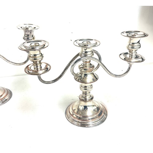 555A - Two silver plated  and copper candelabras measures approximately 9.5 inches tall by 12 wide