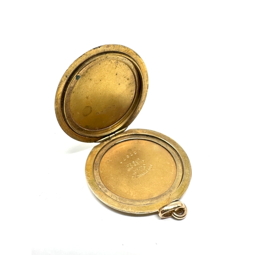 110 - Vintage gold shell & enamel locket measures approx 4cm drop by 3cm wide weight 12.5g