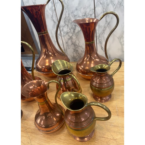 99 - Selection of copper and brass jugs, tallest measures approximately 15 inches