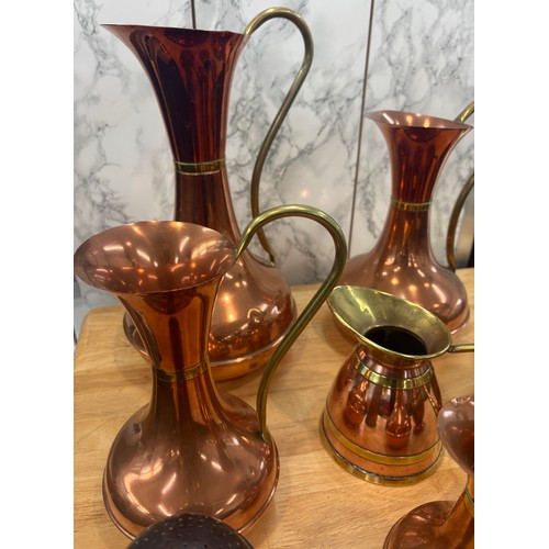 99 - Selection of copper and brass jugs, tallest measures approximately 15 inches