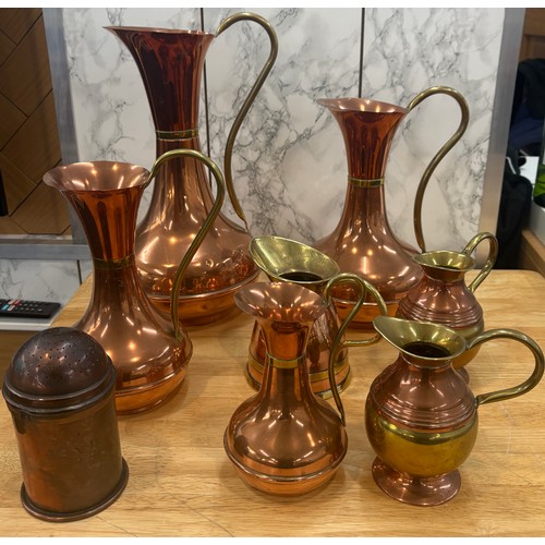 99 - Selection of copper and brass jugs, tallest measures approximately 15 inches