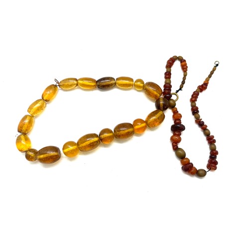 560 - Vintage amber and horn bead necklace, plus one other