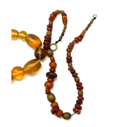 560 - Vintage amber and horn bead necklace, plus one other