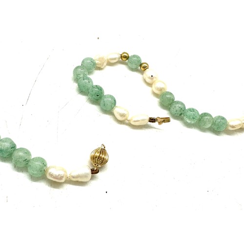 556 - Jade, Pearl and 14ct gold necklace, length 80cm, weight 35g