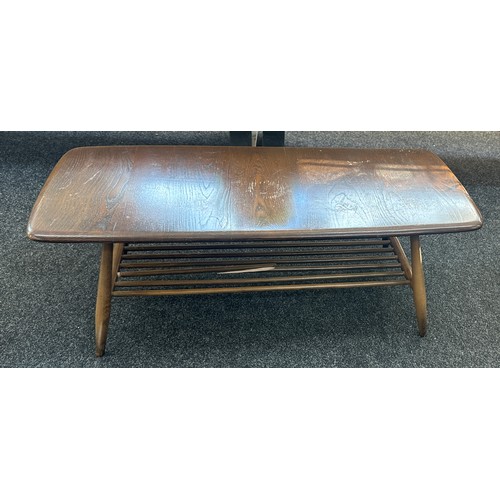 579 - Ercol coffee table measures approximately 41 inches long x 18 wide and 14 tall- broken spindal