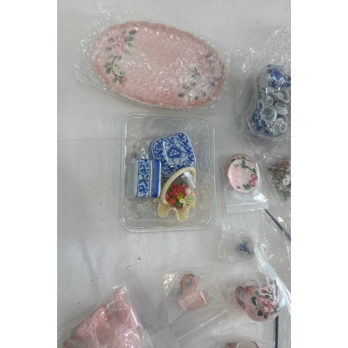 60 - Large quantity of fine porcelain dolls house extras, miniature tea sets, miniature pot flowers, etc