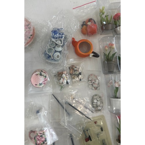 60 - Large quantity of fine porcelain dolls house extras, miniature tea sets, miniature pot flowers, etc