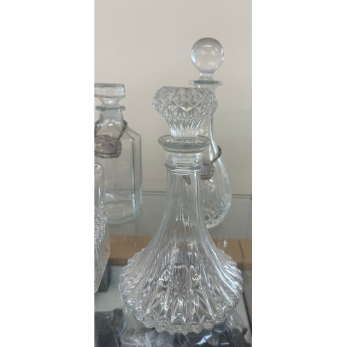 125 - Selection of glass ship decanters with tags