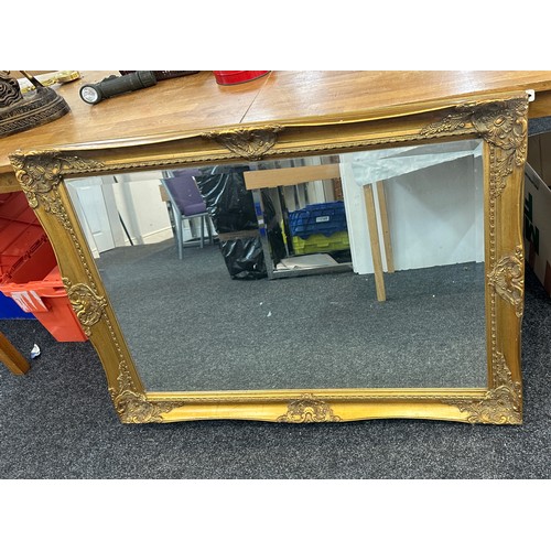 226 - Gilt framed wall hanging mirror measures approx 42 inches wide by 30 tall