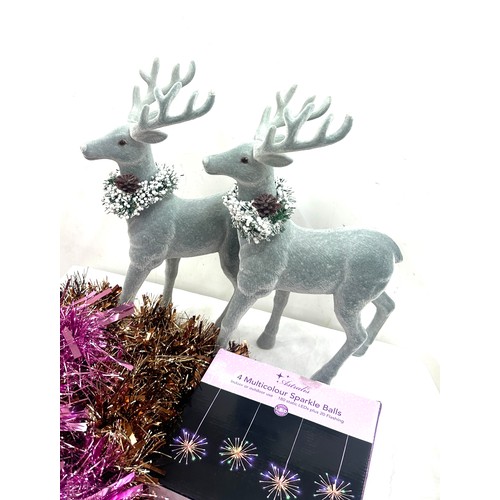 205 - Selection of Christmas decorations to include a pair of Reindeer figures, tinsel, baubles etc