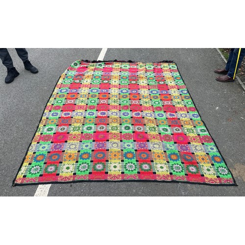 179 - Large hand knitted floral throw measures approximately 95 inches long by 75 wide