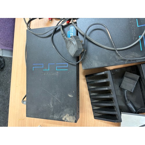 218 - Selection of 3 Play station 2 consoles, a selection of PS2 games and a large selection of controller... 