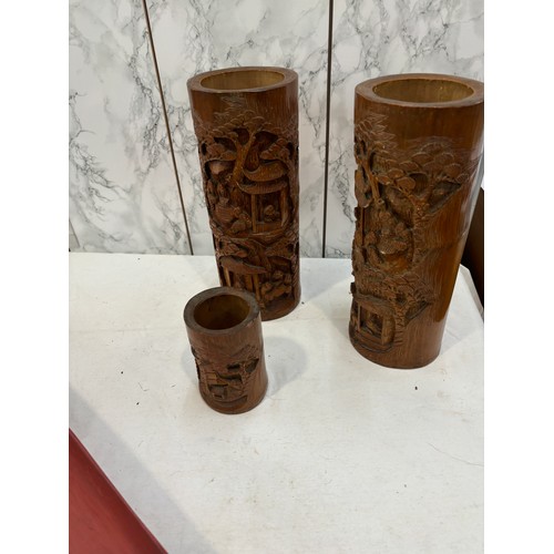 114 - Carved bamboo vases and a aboriginal spear thrower