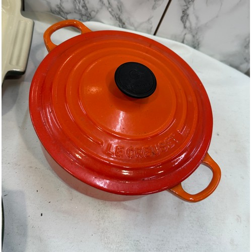 19 - Four pieces of Le Creuset a lidded pot and three varied size dishes