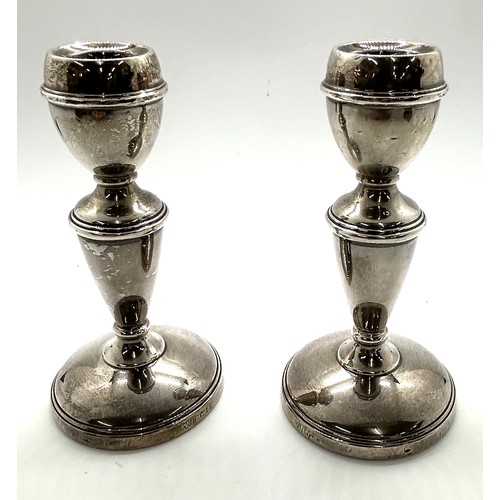 509 - Pair of hallmarked silver candlesticks height 12cm, total overall weight 254g (filled base)