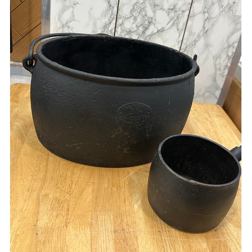 286 - Cast iron pot and sauce pan largest measures approximately 8.5 inches tall x 14 wide