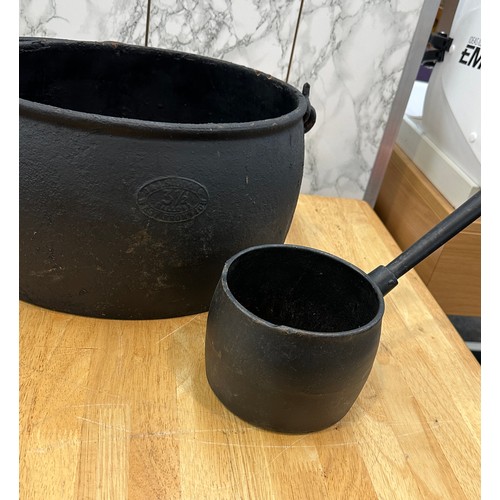 286 - Cast iron pot and sauce pan largest measures approximately 8.5 inches tall x 14 wide