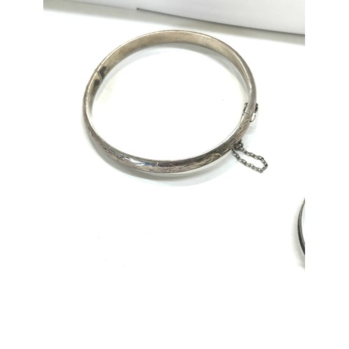 498 - Three silver bangles total weight 24g