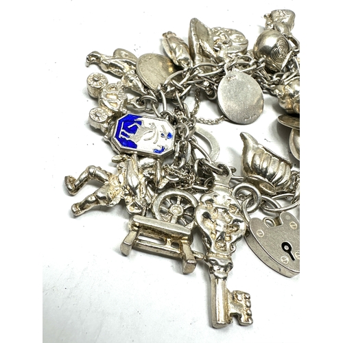 254 - Vintage silver charm bracelet and charms weight 91g