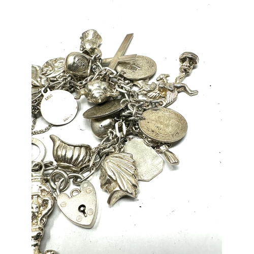 254 - Vintage silver charm bracelet and charms weight 91g