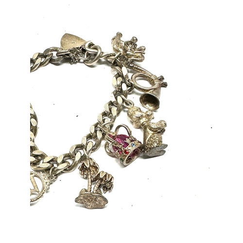 256 - Vintage silver charm bracelet and charms weight 65g