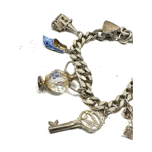 256 - Vintage silver charm bracelet and charms weight 65g