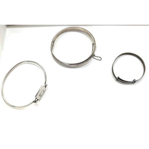 498 - Three silver bangles total weight 24g