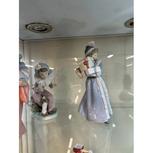 538 - Three vintage Nao figurines one ' 1985 girl with presents', ' Listen to the Harlequinn with dog' and... 