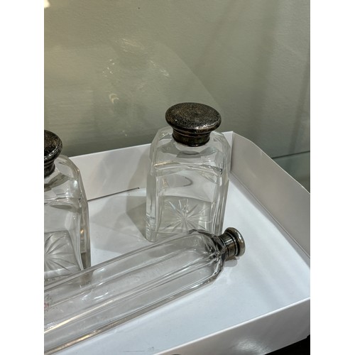 511 - Three silver topped glass scent bottles