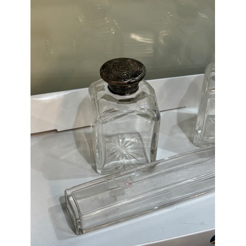 511 - Three silver topped glass scent bottles