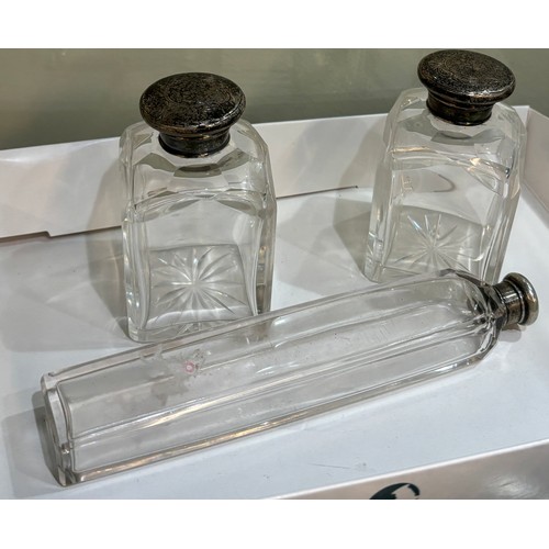 511 - Three silver topped glass scent bottles