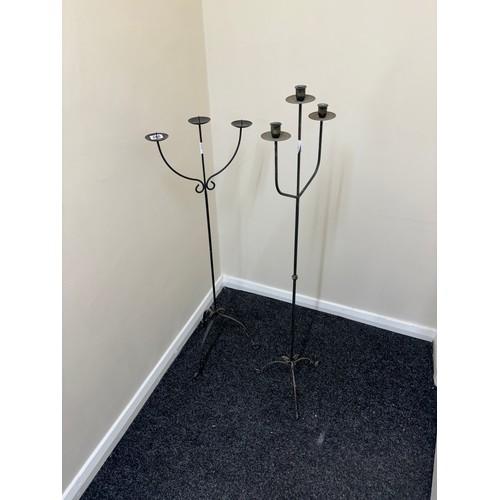 392 - Cast iron candle stick holders tallest measures approximately 49 inches tall