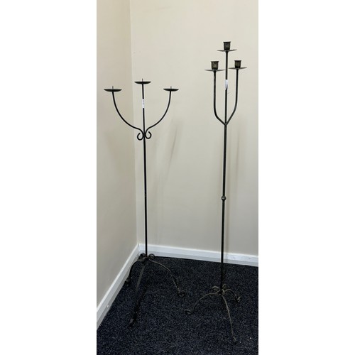 392 - Cast iron candle stick holders tallest measures approximately 49 inches tall