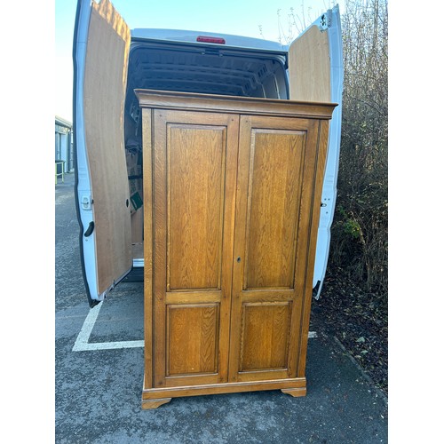 421J - 2 Door light oak wardrobe measures approximately 78 inches tall 44 inches wide 24 inches depth