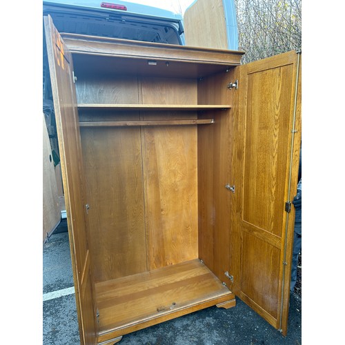 421J - 2 Door light oak wardrobe measures approximately 78 inches tall 44 inches wide 24 inches depth