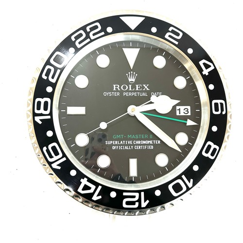 39 - Rolex wall clock in working order- crack to glass