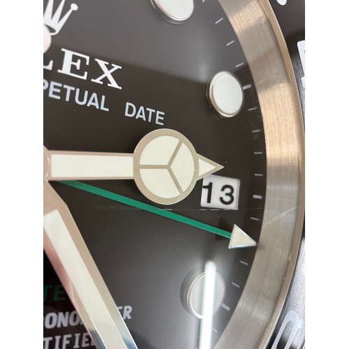 39 - Rolex wall clock in working order- crack to glass