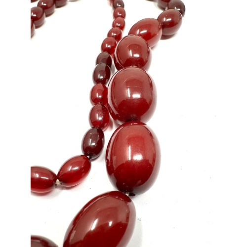 96 - Cherry Amber / bakelite bead necklace lagest bead measures approx 26mm by 19mm length 78cm long weig... 