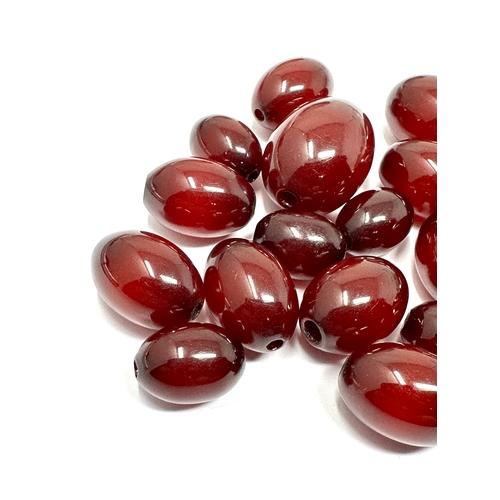 99 - selection of Cherry Amber bakelite beads largest bead measures approx 22mm by 16mm weight 28g