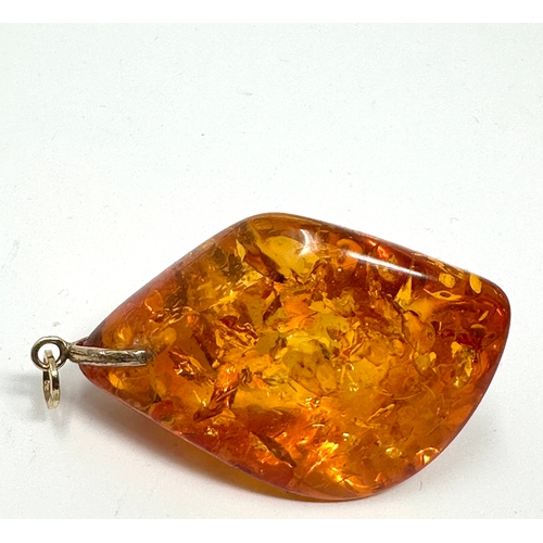 101 - Large 9ct gold mounted Amber pendant measures approx 6cm drop weight 23.8g xrt tested as 9ct gold