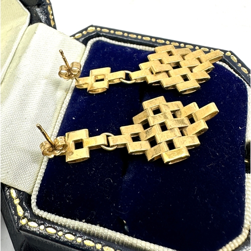 114 - A PAIR OF 9CT GOLD EARRINGS; articulated gate link drops to stud fittings weight 3.4g