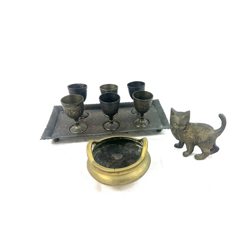 528 - Selection of collectable items to include a brass cat a sensor and a set of 6 brass goblets on a tra... 