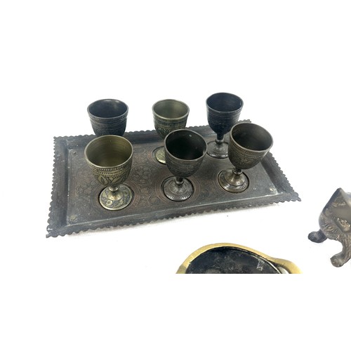 528 - Selection of collectable items to include a brass cat a sensor and a set of 6 brass goblets on a tra... 