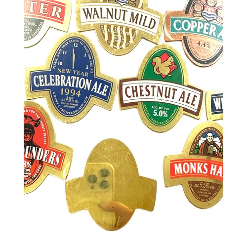 556 - Selection of vintage brass beer pump badges