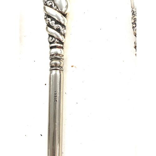 550 - Early pair of sterling silver sugar tongs and button hooks with silver handles and shoe horn