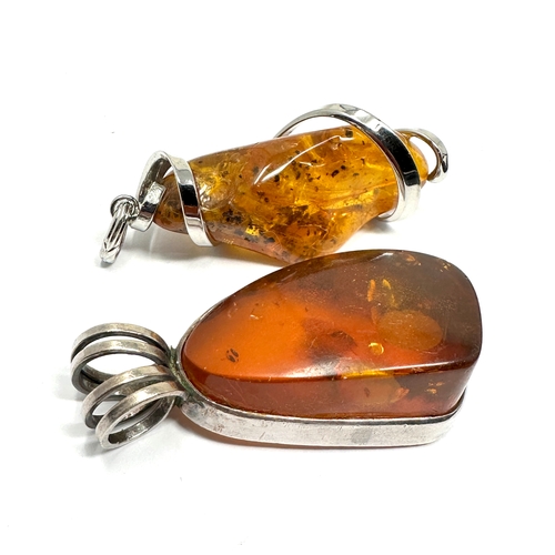 295 - 2 large silver & amber set pendants weight approx 28g measure approx 5.5cm