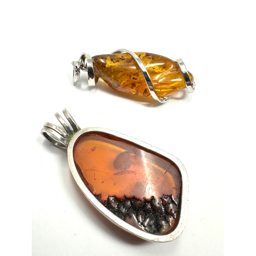 295 - 2 large silver & amber set pendants weight approx 28g measure approx 5.5cm