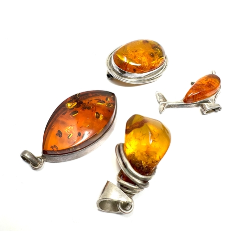 296 - 4 silver amber set pendants & brooch weight 35g