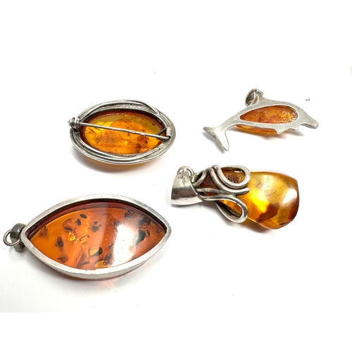 296 - 4 silver amber set pendants & brooch weight 35g