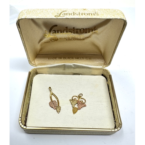 139 - 2 Landstroms black hills 10k 3 coloured gold pendants in original box weight 1.5g